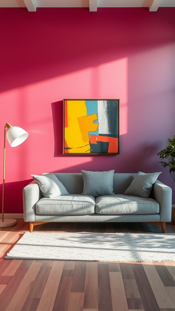 Living room with a grey couch and vibrant pink accent wall featuring abstract art