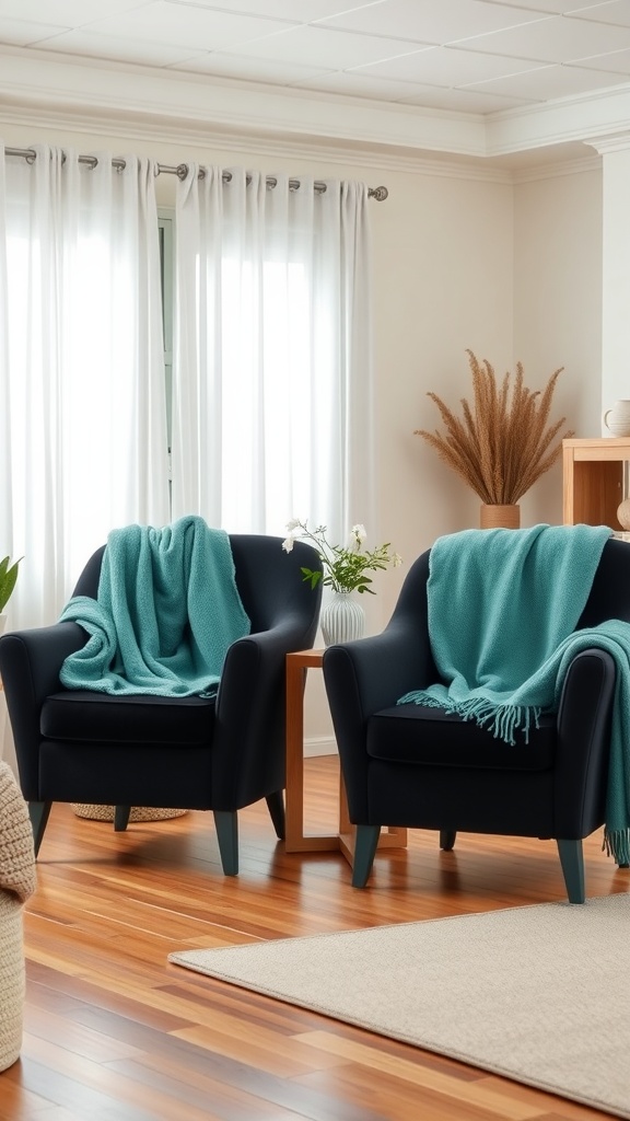 Two black chairs with teal throw blankets draped over them, a small table in between, and natural decor in the background.