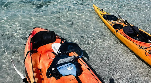 two different types of kayaks on the beach